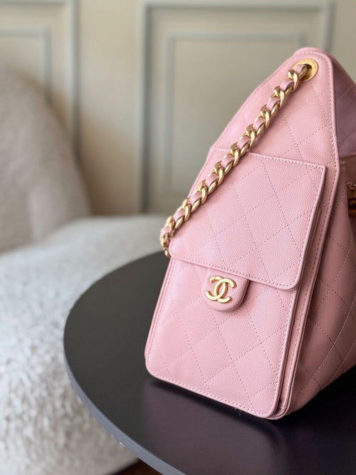 Pink Chanel quilted handbag with front flap pocket and gold chain shoulder strap