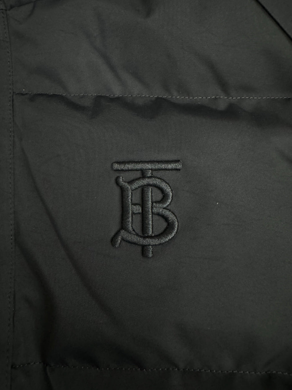 Black jacket fabric panel with embroidered B monogram logo