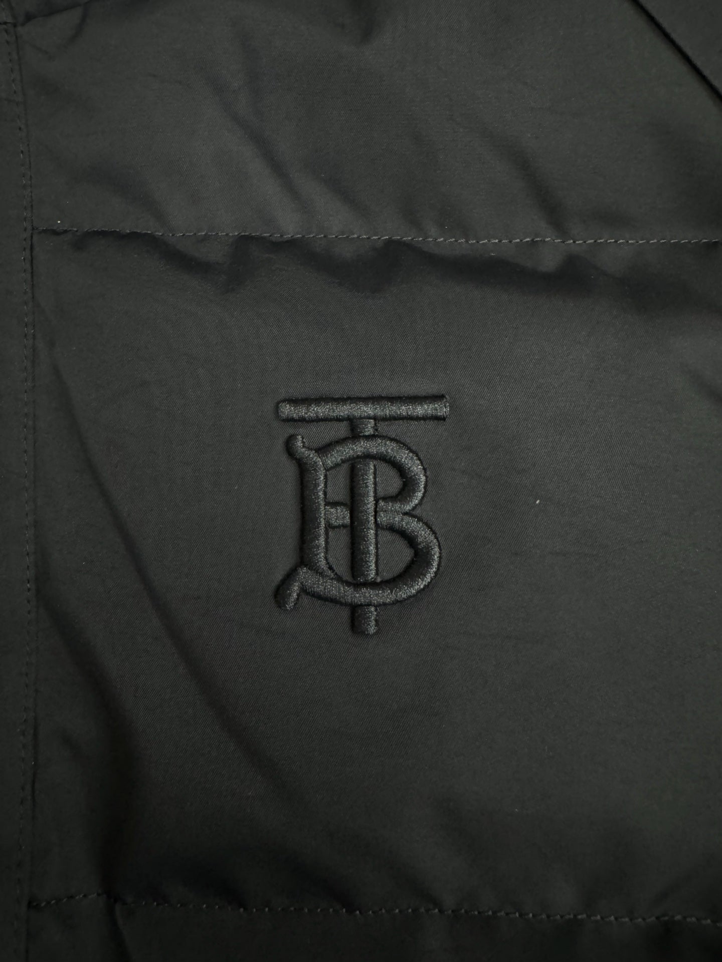 Black jacket fabric panel with embroidered B monogram logo