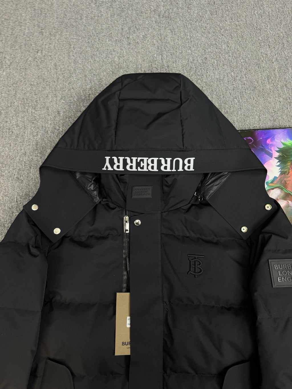 Black hooded puffer jacket with Burberry logo detail on hood panel