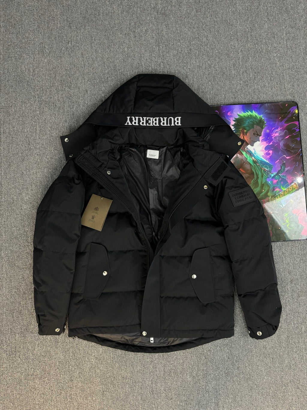 Black hooded puffer jacket with flap pockets and Burberry hood label
