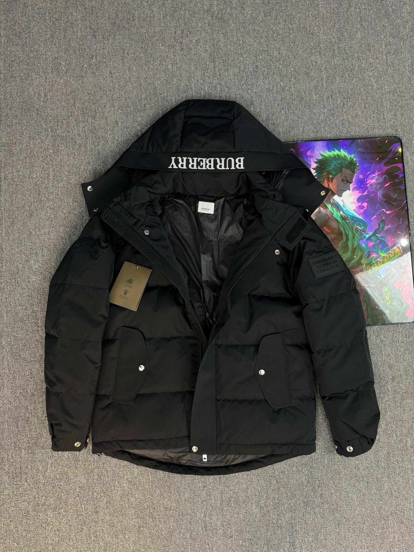 Black hooded puffer jacket with flap pockets and Burberry hood label