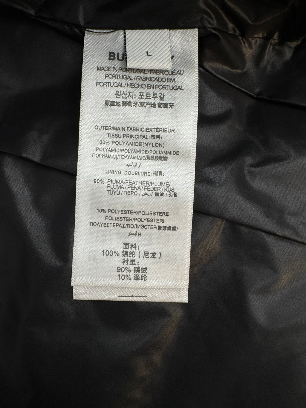 Black jacket interior care label with fabric composition details