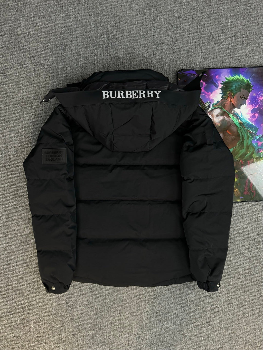 Black hooded puffer jacket back view with BURBERRY logo on collar