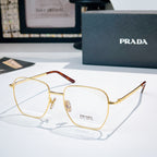Prada glasses with gold square frames and clear lenses, side logo on temple.