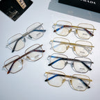 Assorted Prada eyeglasses with clear lenses and mixed metal frames arranged on display.
