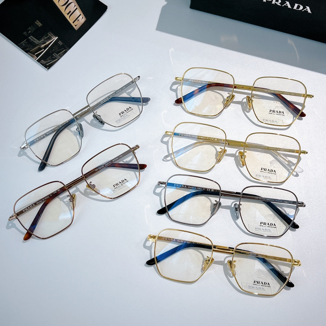Assorted Prada eyeglasses with clear lenses and mixed metal frames arranged on display.