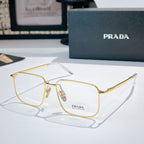 Prada eyeglasses with gold metal frame and clear lenses