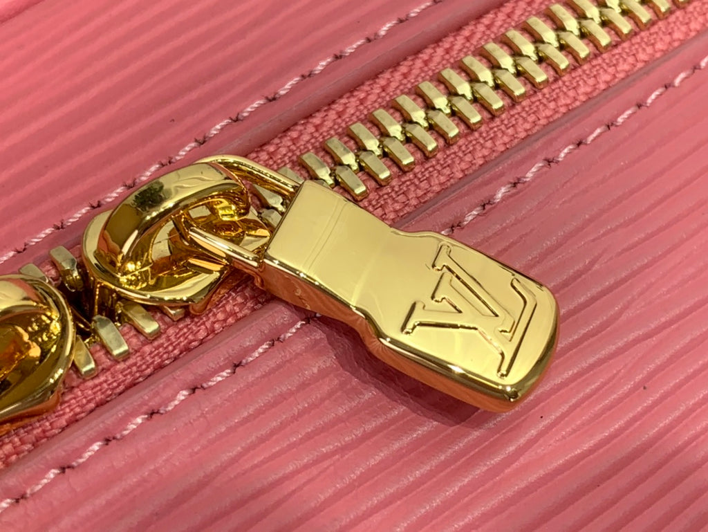 Louis Vuitton gold-tone zipper pull on pink Epi leather with stitched trim.