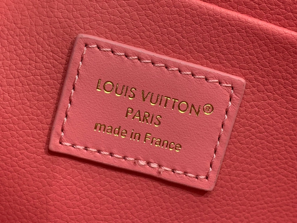 Louis Vuitton pink Epi leather authenticity label reading Louis Vuitton Paris, made in France.