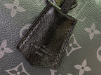 Louis Vuitton monogram handbag leather patch with dangling strap loop, close-up.