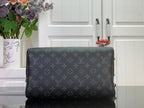 Louis Vuitton monogram handbag with structured body and dark leather trim, back view.