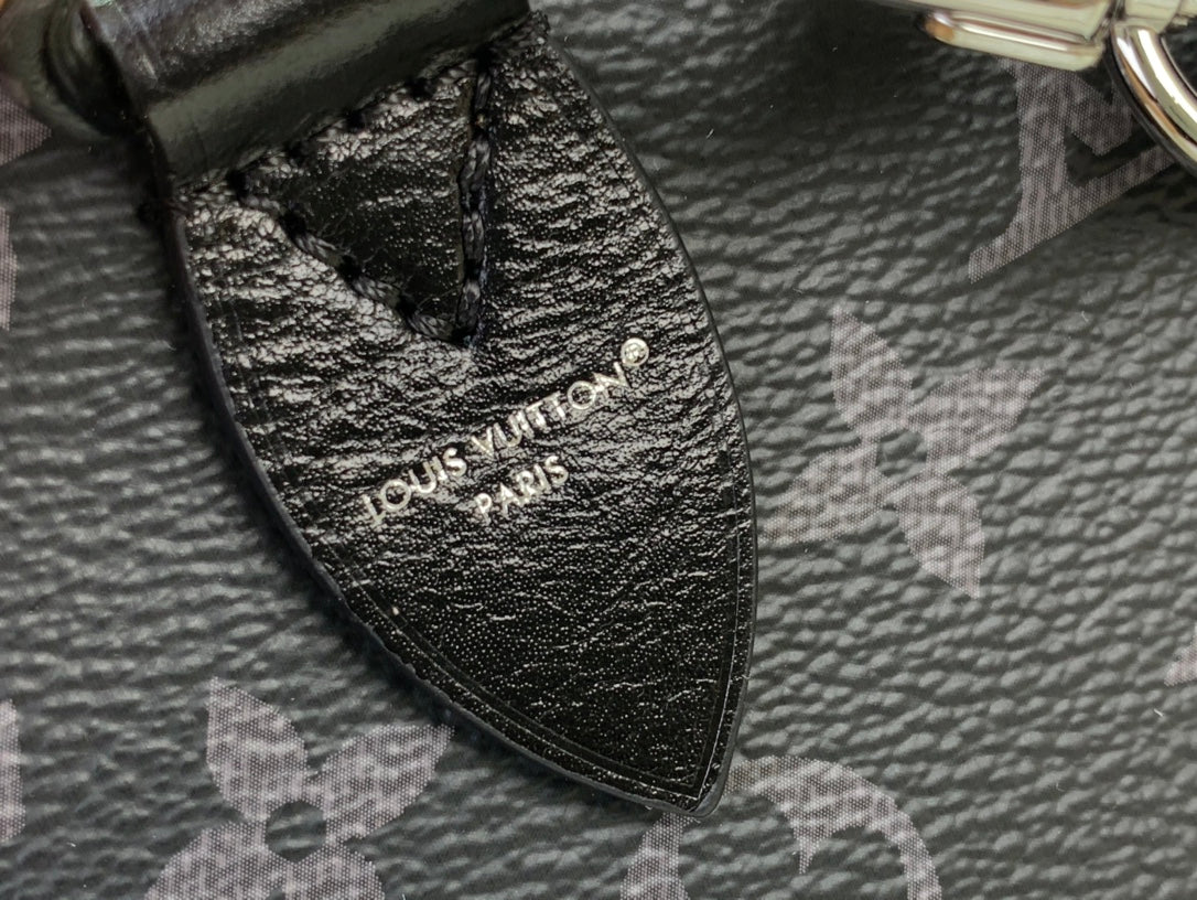 Louis Vuitton monogram handbag interior tag detail on textured dark leather.