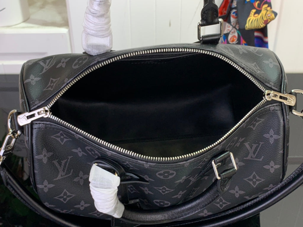 Louis Vuitton monogram handbag open top with black interior and zipper, angled view.