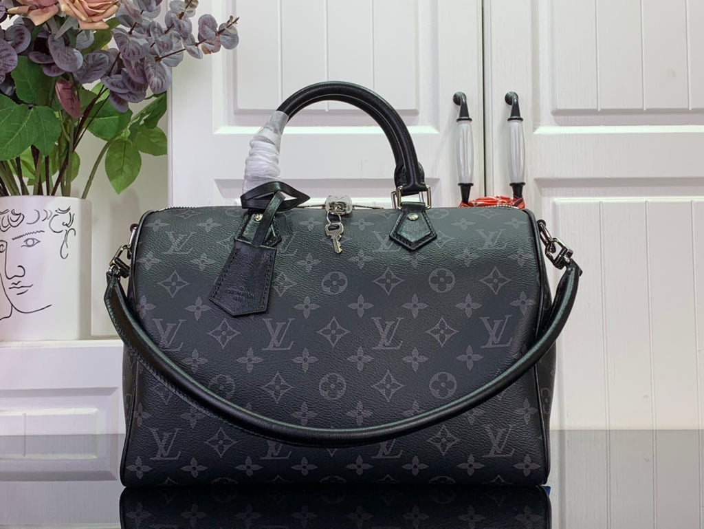 Louis Vuitton monogram handbag with top handles and dark leather trim, front view.
