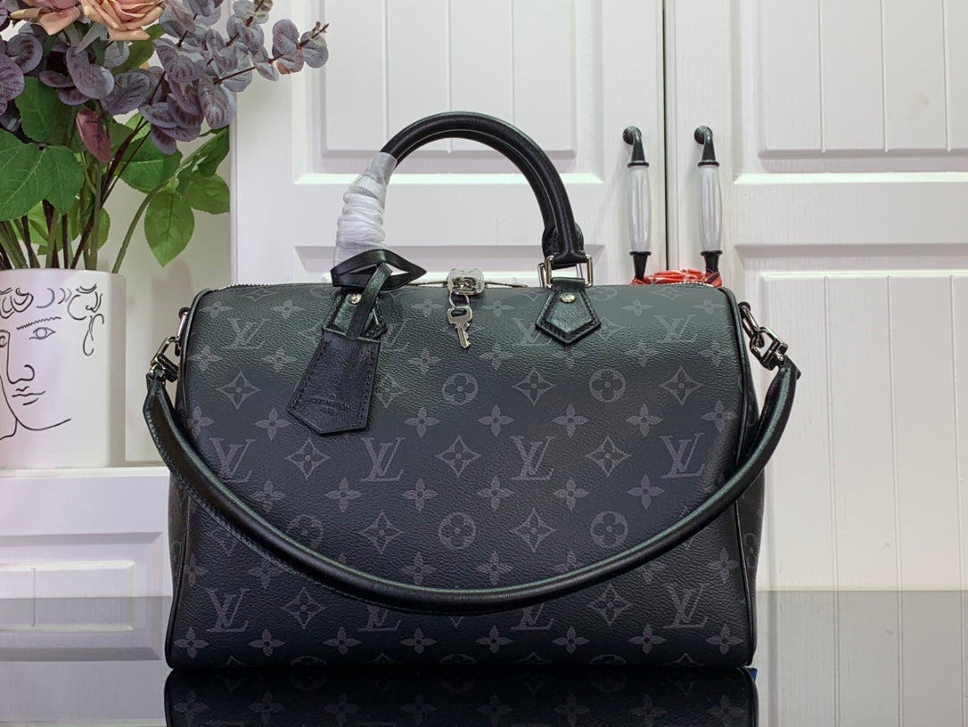 Louis Vuitton monogram handbag with top handles and dark leather trim, front view.