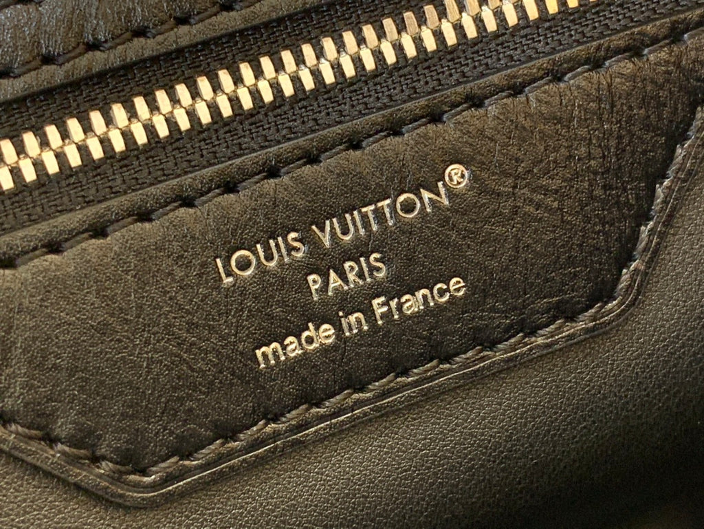 Louis Vuitton handbag leather label reading “Louis Vuitton Paris” and “made in France”.