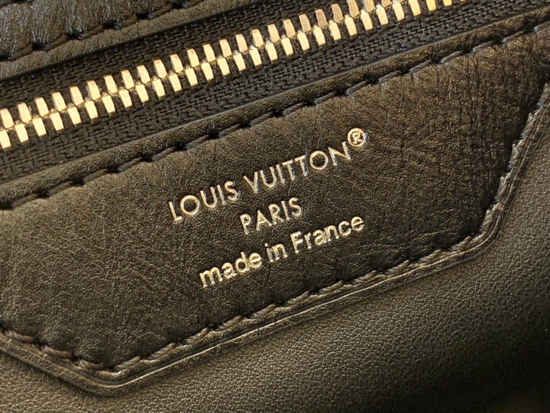 Louis Vuitton handbag leather label reading “Louis Vuitton Paris” and “made in France”.