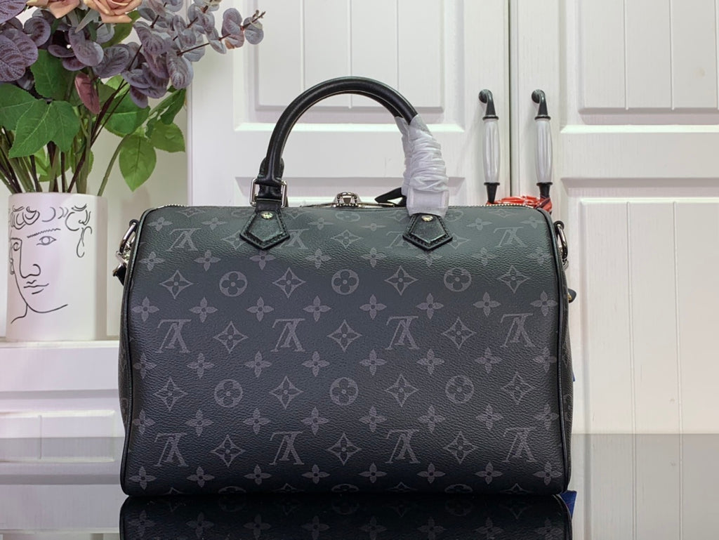 Louis Vuitton monogram handbag with top handles and dark leather trim, front view close-up.