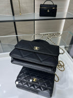 Black Chanel flap crossbody bag with gold CC emblem and chain strap