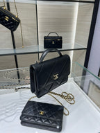 Black Chanel mini top-handle bag with gold CC clasp and chain strap