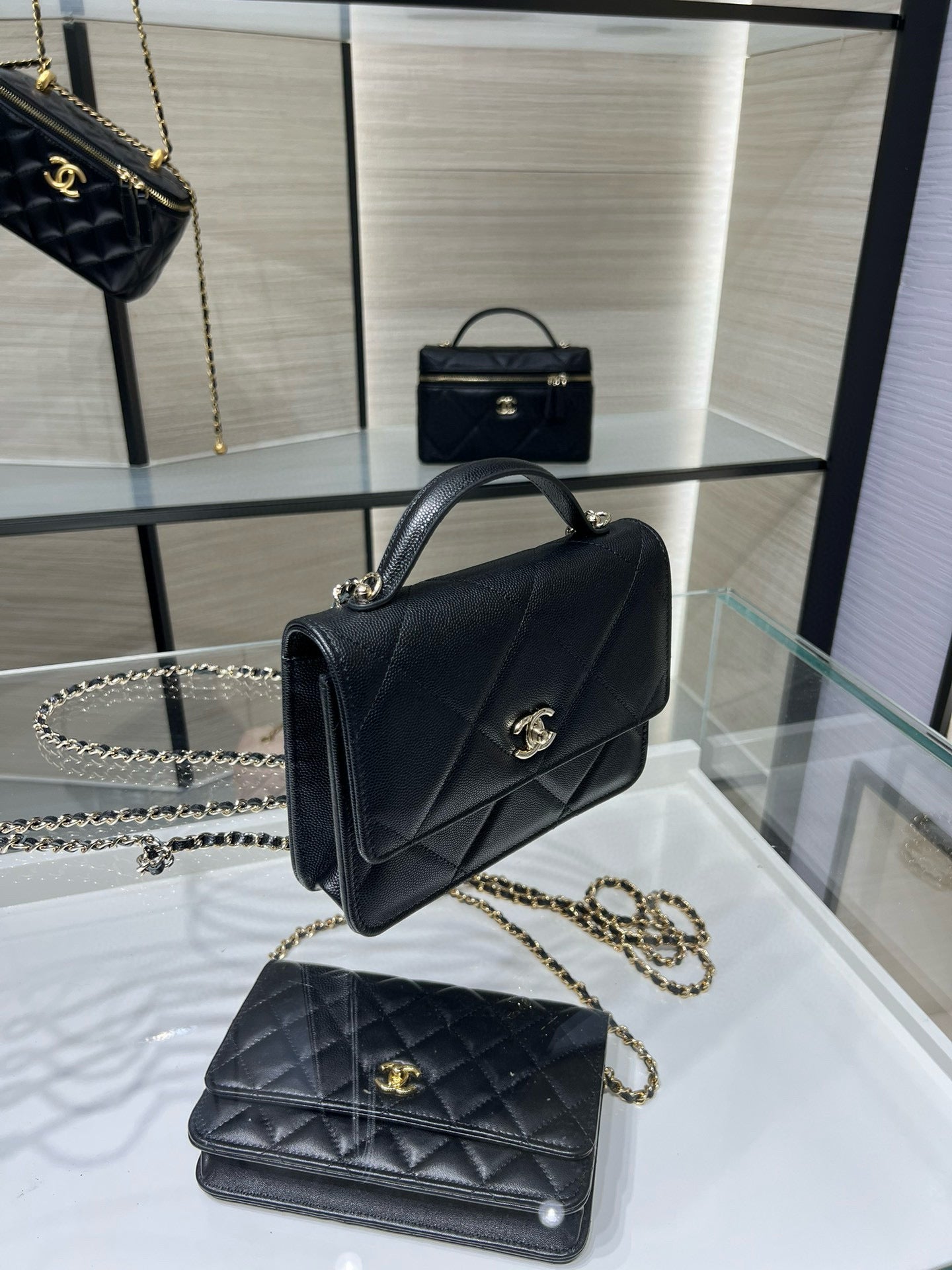 Black Chanel mini top-handle bag with gold CC clasp and chain strap