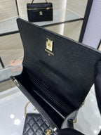 Black Chanel tote-style bag with front logo plate and long chain strap