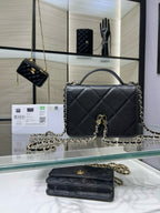 Black quilted Chanel satchel bag with gold CC turn-lock and chain strap