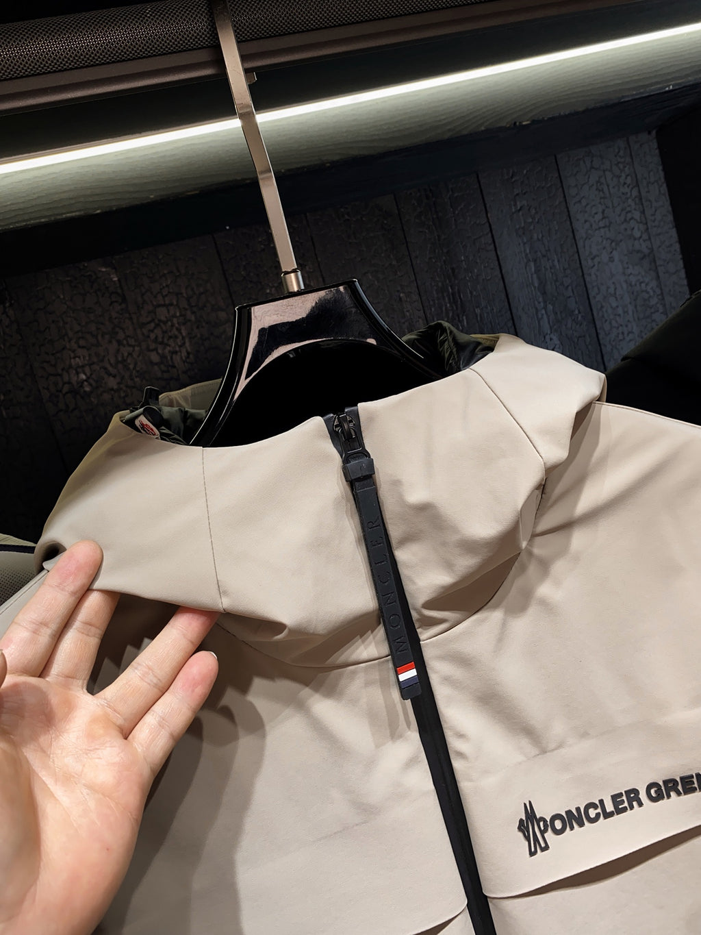 Beige hooded jacket with front zipper and logo print on chest