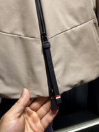 Beige jacket with black zipper pull and red-white-blue stripe tape