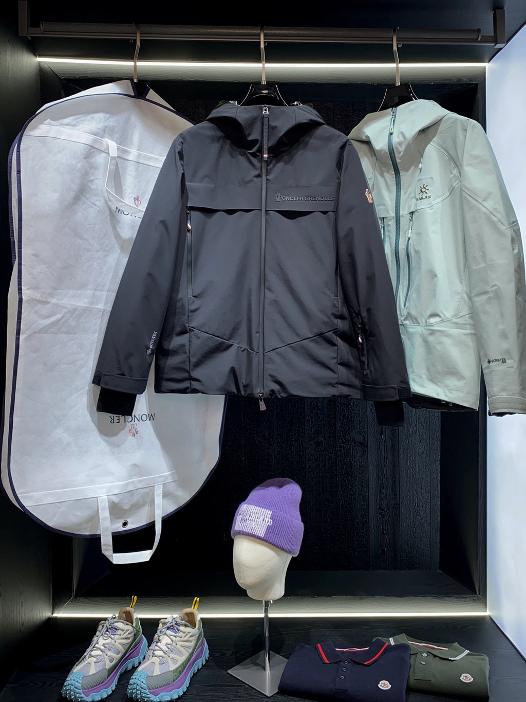 Navy and mint long parka jackets with front zippers and logo patches