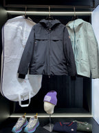 Navy and mint long parka jackets with front zippers and logo patches