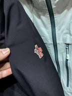 Dark parka sleeve with embroidered Moncler logo patch