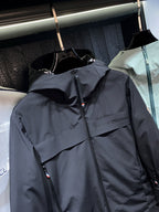 Dark long parka jacket with front zipper and chest logo detail
