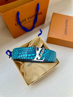 Turquoise dotted belt with gold LV buckle over a beige pouch