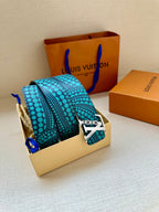 Turquoise dotted belt with gold LV buckle on a box insert