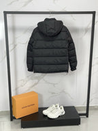 Black long puffer jacket, back view with hood and padded yoke