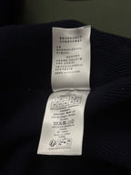 Inner care label on dark knit hoodie with fabric composition and size details