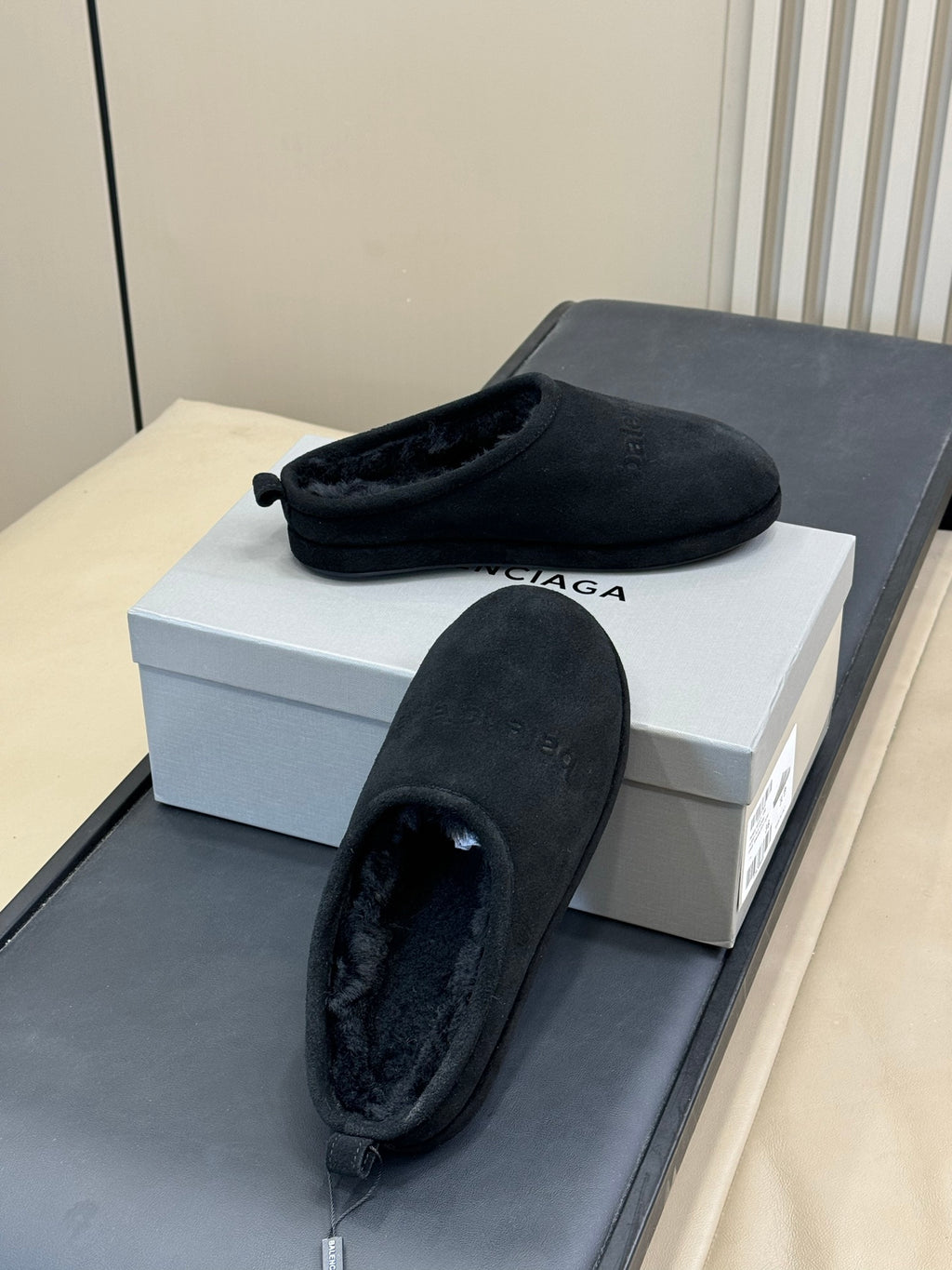 Black suede mule with plush interior, slip-on design