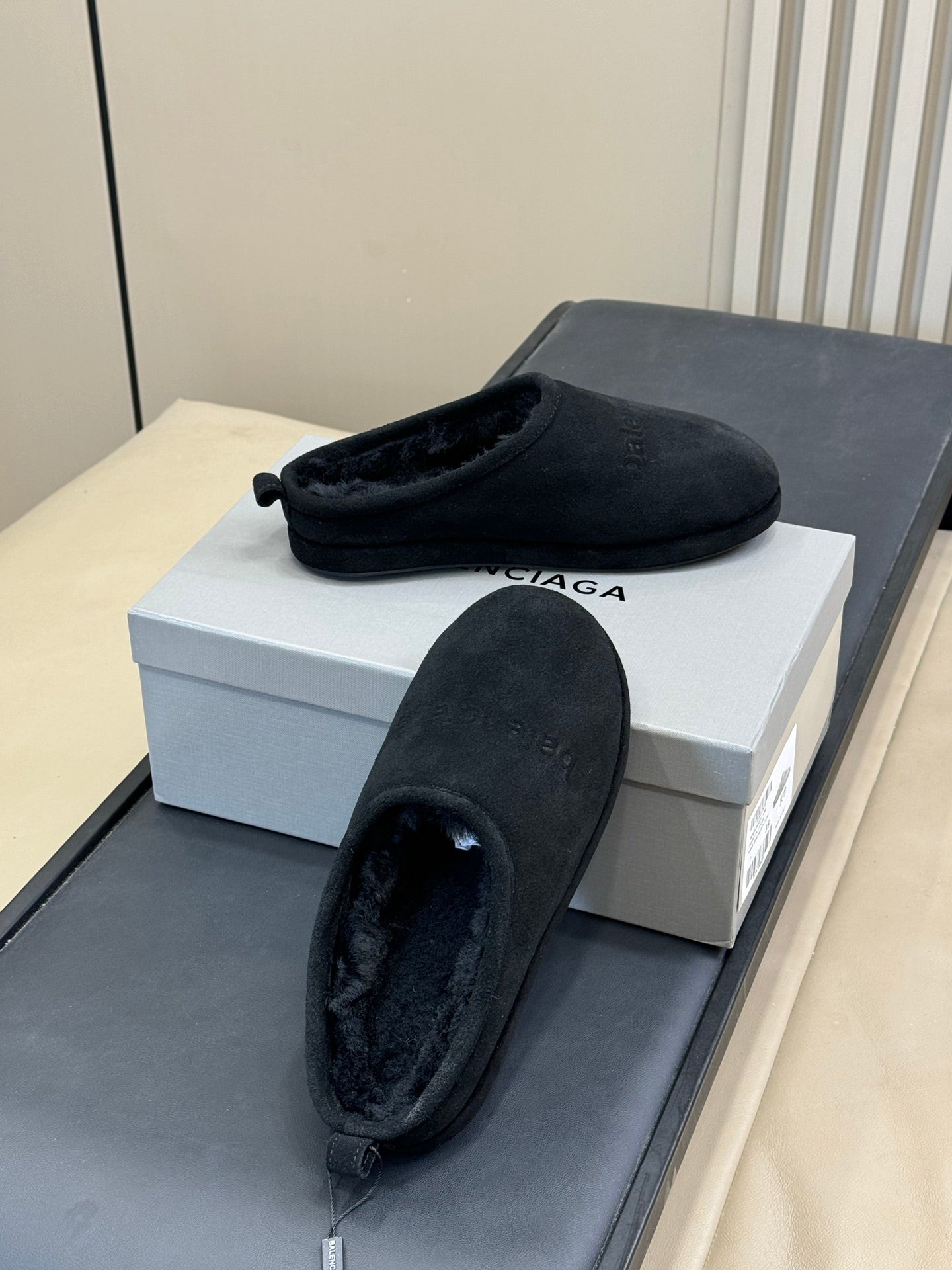 Black suede mule with plush interior, slip-on design