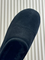 Black suede upper close-up with rounded cuff opening