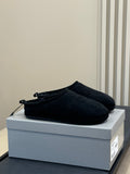 Black suede slip-on mules with bow-tie detail at instep