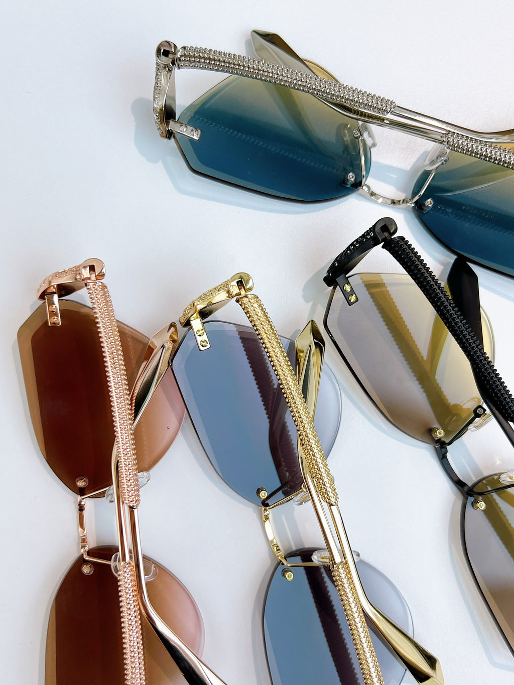 Assorted Bvlgari sunglasses with blue, gold, and brown lenses on display