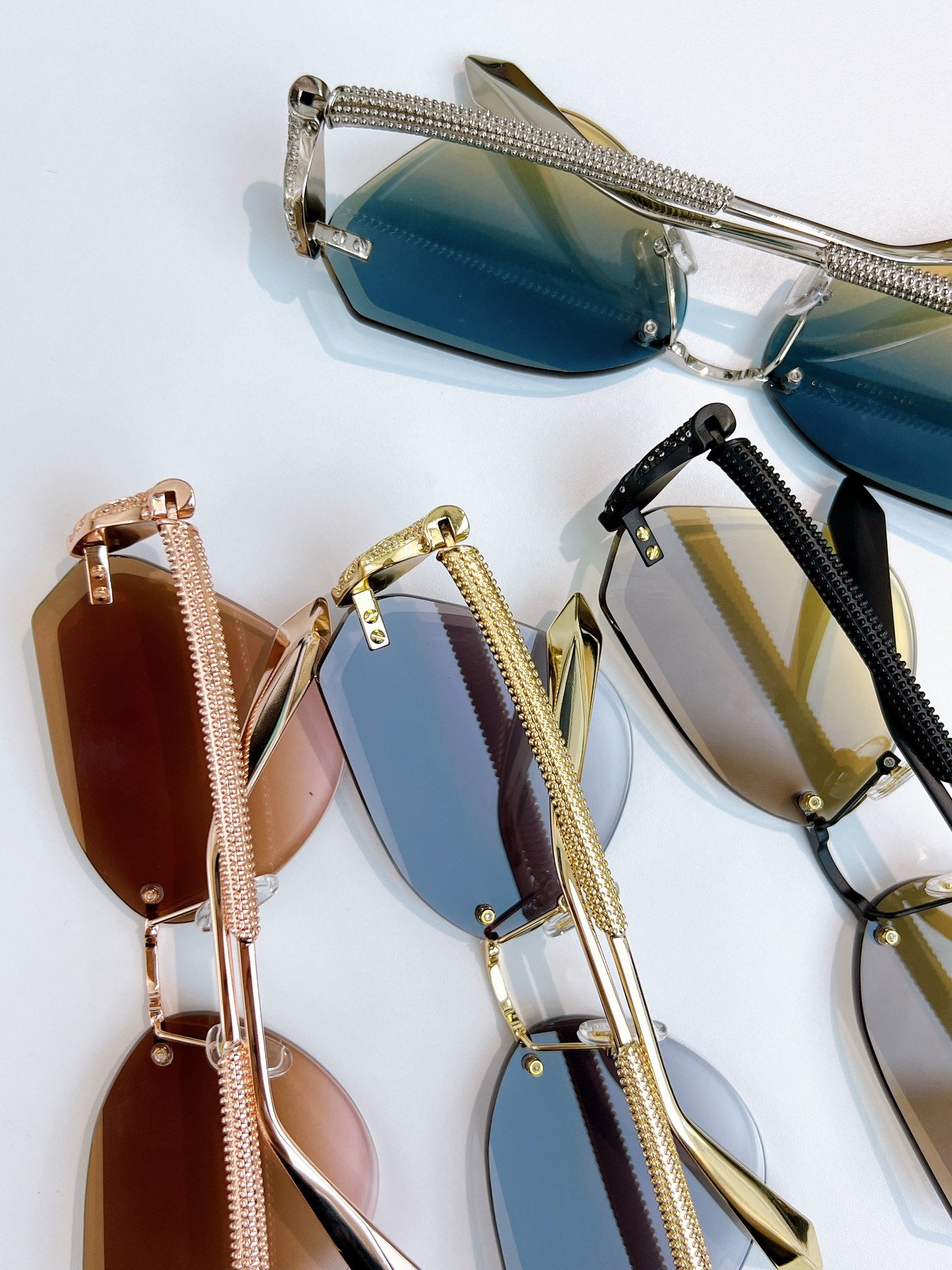 Assorted Bvlgari sunglasses with blue, gold, and brown lenses on display