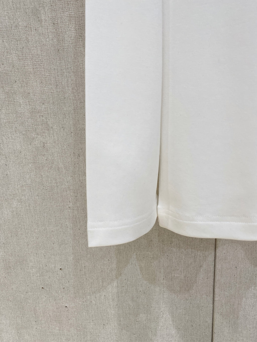 White long-sleeve T-shirt hem and side view