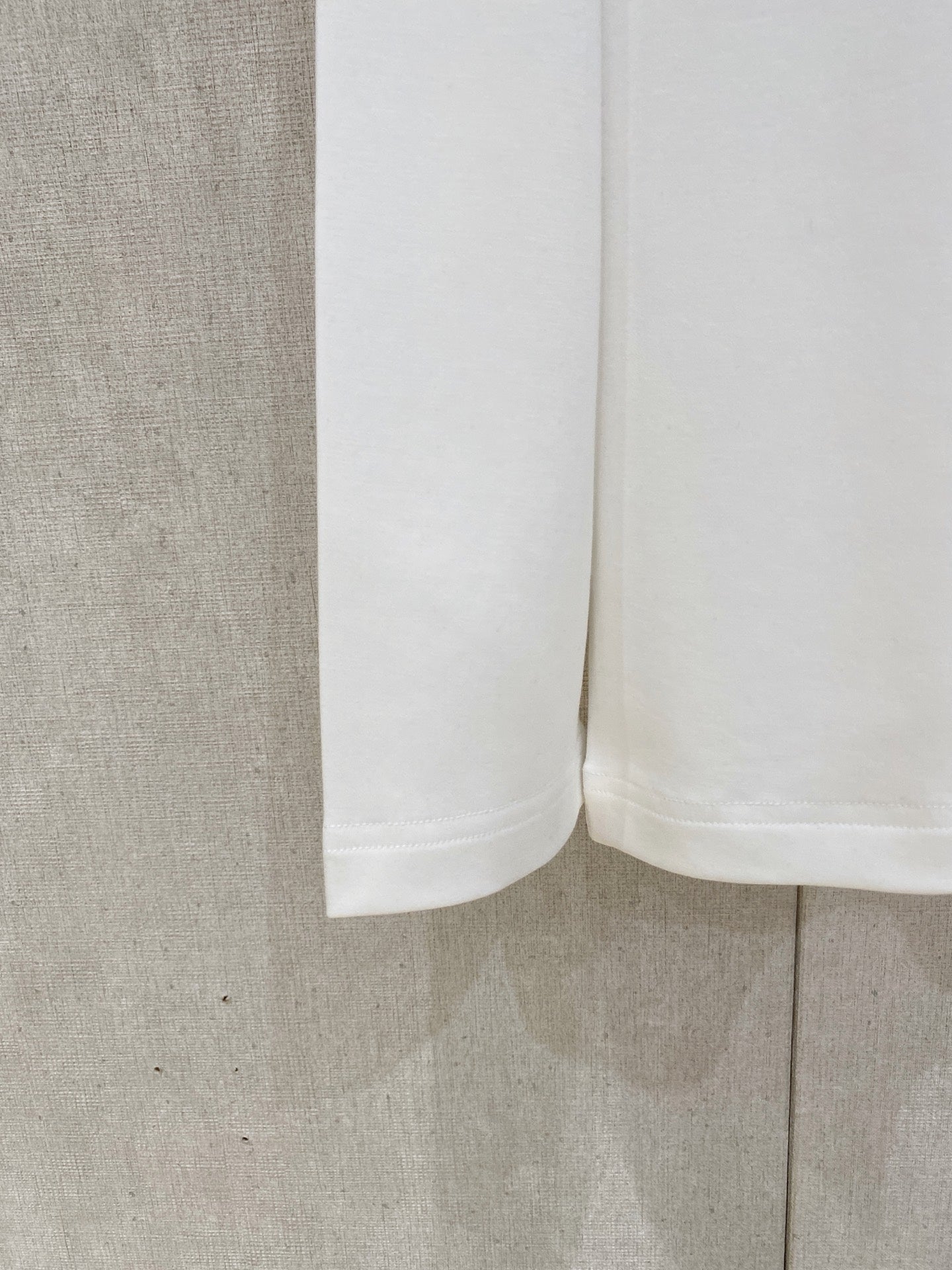 White long-sleeve T-shirt hem and side view