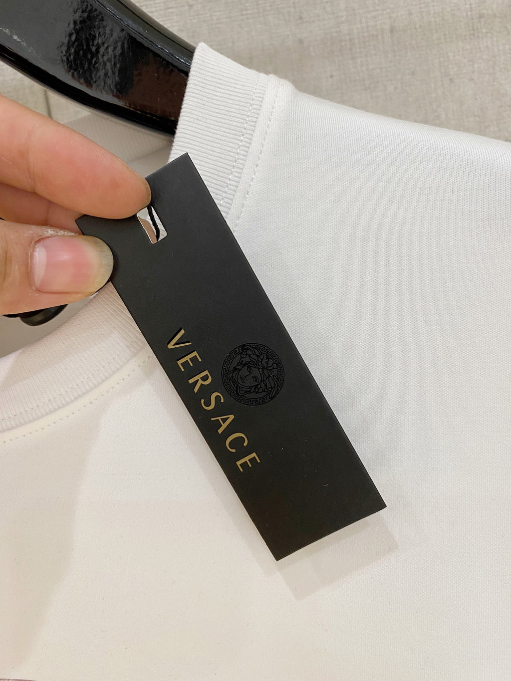 White Versace long-sleeve T-shirt with black size tag near collar