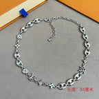 Louis Vuitton silver-tone charm bracelet featuring clover, star charms and oval link chain