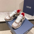 Dior unisex low-top sneakers with beige uppers, white laces, black details, and red lining