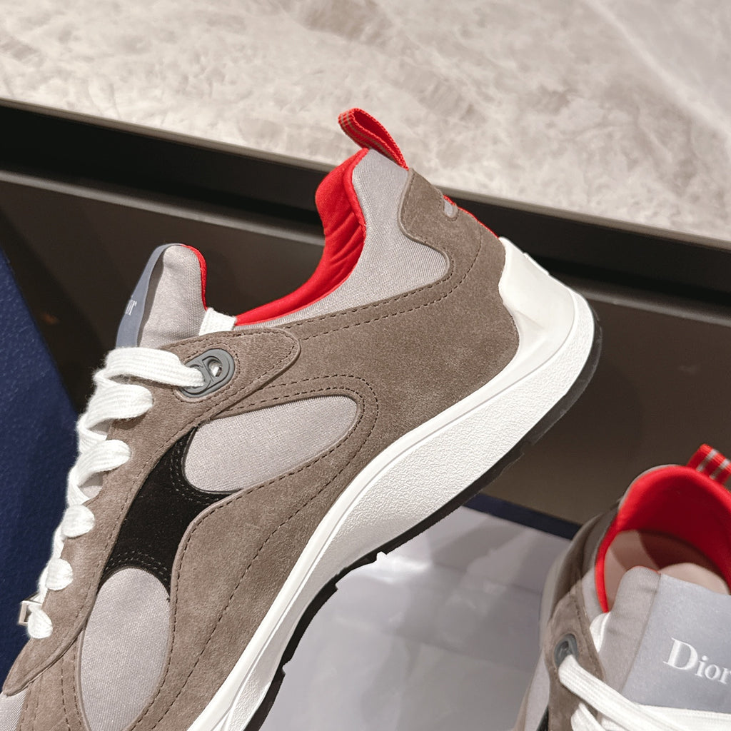Dior unisex sneaker close-up: beige suede, black side panel, white laces, and red heel collar